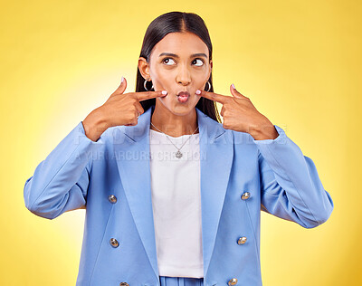 Buy stock photo Face, fingers on cheek and a woman in studio for positive attitude, dimples and emoji. Indian model person or student thinking of fashion, comic and funny face or silly mood on a yellow background