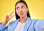 Business woman, peace sign and studio selfie with funny face, pouting and emoji by yellow background. Entrepreneur, hand and thinking with kiss, comic face and icon for vote, social media or web blog