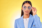 Thinking, woman and face with sunglasses in studio, yellow background and mockup space with confident model with style. Stylish, frames and gen z person with an idea with cool fashion or glasses