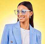 Young business woman, sunglasses and studio with thinking, vision and smile by yellow background. Entrepreneur, fashion model and happy with stylish frame, lens and trendy suit with ideas for beauty