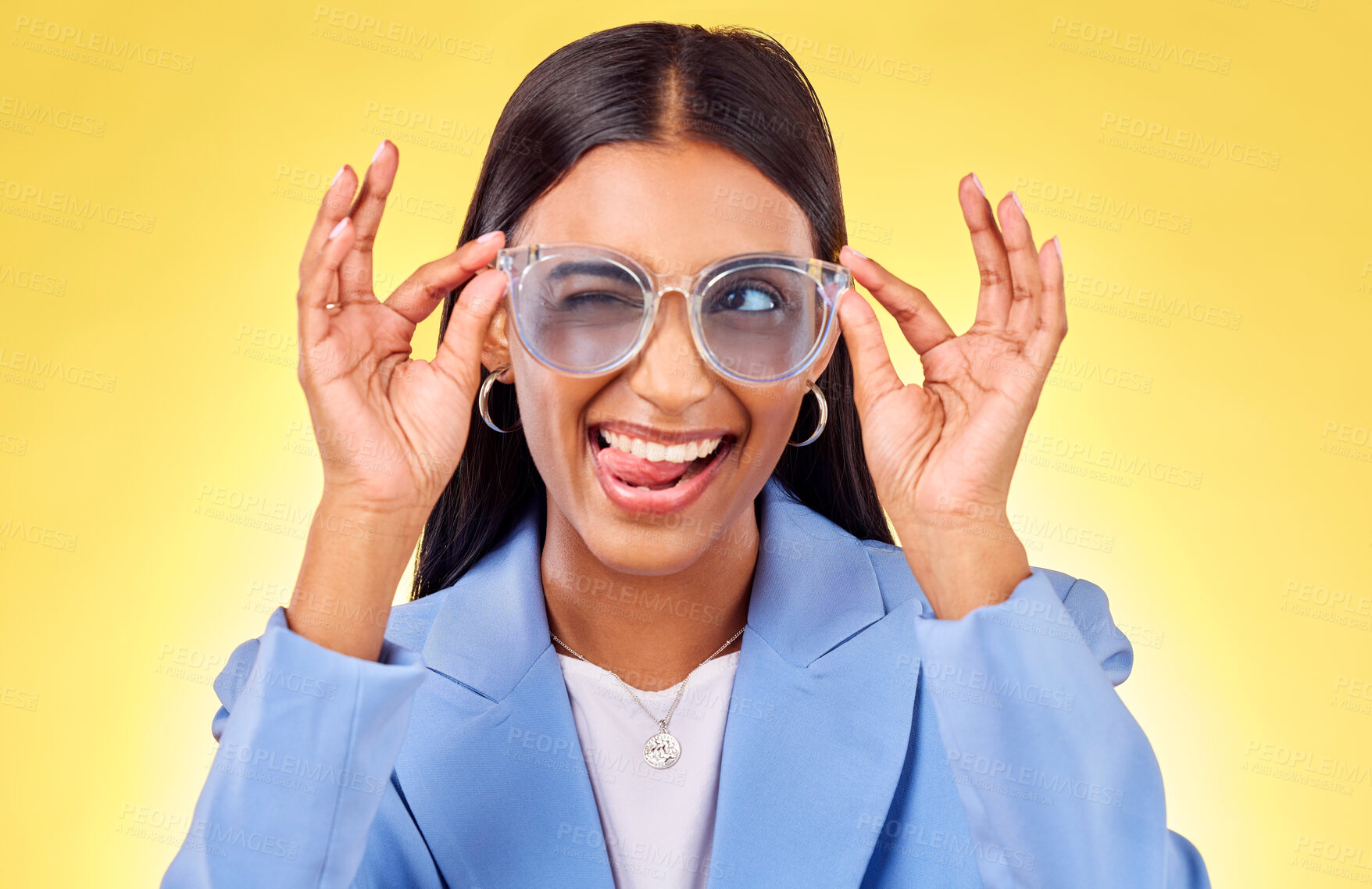 Buy stock photo Funny, silly woman and sunglasses with tongue out, comedy and face in a studio. Yellow background, crazy and young female person with modern fashion, trendy cool style and creative work clothing