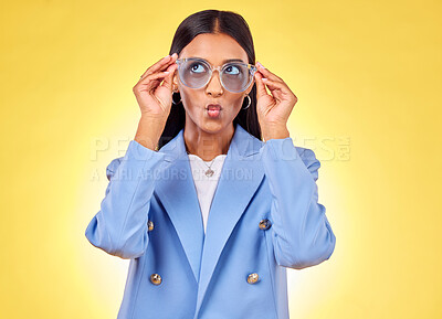 Buy stock photo Funny, happy woman and sunglasses with kiss, comedy and silly face in a studio. Yellow background, pout and young female person with modern fashion, trendy cool style and creative work clothing