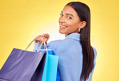 Buy stock photo Shopping, retail and portrait of woman as a customer happy for style or fashion isolated in a studio yellow background. Smile, product, sale and young person with discount, deal or promo on clothes