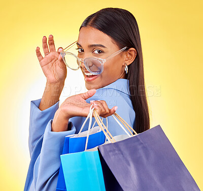 Buy stock photo Shopping, fashion and portrait of woman as a customer happy for retail isolated in a studio yellow background. Smile, product and sale for young person with style discount, deal and promo on clothes