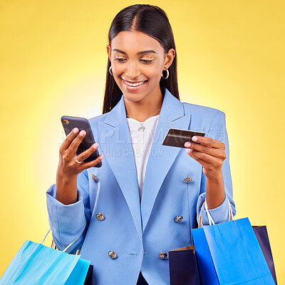 Buy stock photo Woman, phone and credit card with shopping bag, studio and fintech for payment by yellow background. E commerce, smartphone and banking info with smile, discount and sale on mobile app for fashion