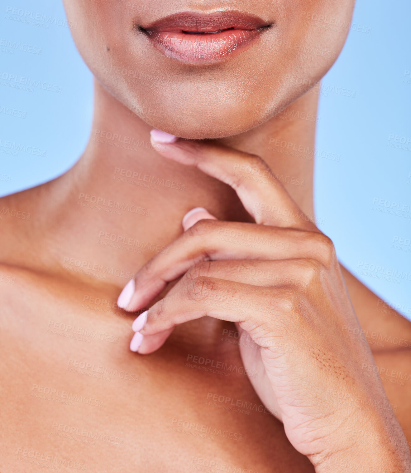 Buy stock photo Hand, mouth and beauty with a woman closeup in studio on a blue background for natural skin wellness. Skincare, lips and finger of a model touching her face for an aesthetic manicure or cosmetics