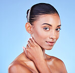 Skincare, portrait and woman in studio for wellness, cosmetic or treatment on blue background. Face, beauty and Indian lady model with hand touching glow, skin or dermatology or smooth results