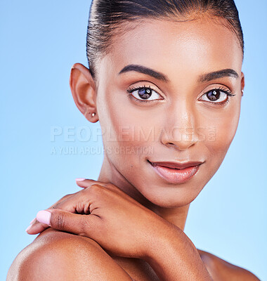 Buy stock photo Portrait, skincare and Indian woman in studio for beauty, care or natural cosmetics on blue background space. Face, glow and female model with dermatology, wellness or pamper routine satisfaction