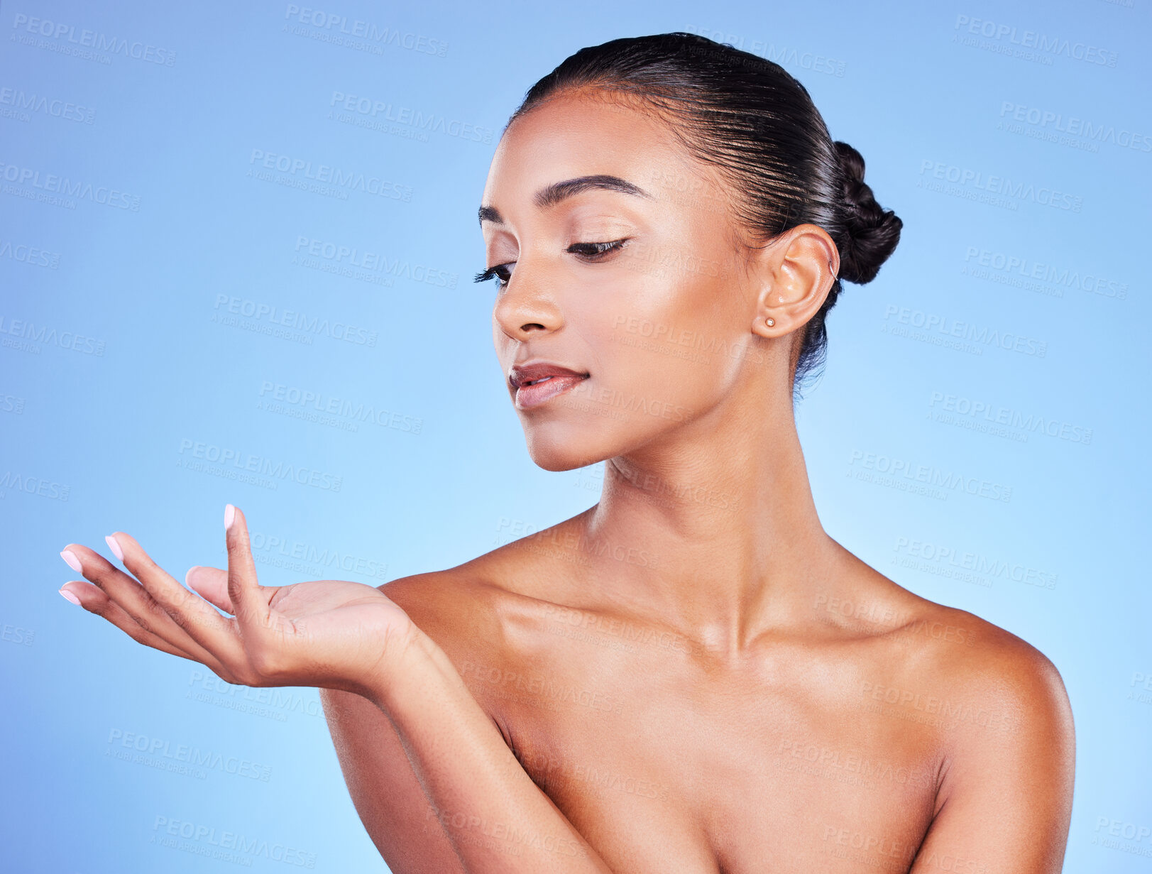 Buy stock photo Hand, thinking and woman on a blue background for beauty, advertising or skincare in studio. Fingers, idea and Indian model with a gesture or palm for makeup, glow of skin or marketing on a backdrop