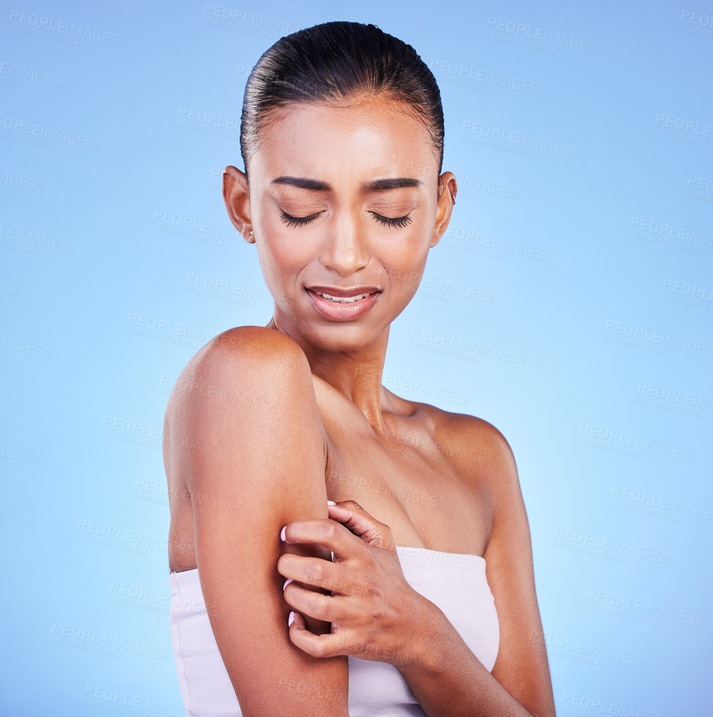 Buy stock photo Arm pain, stress and sad woman in studio with arthritis, osteoporosis or emergency on blue background. Shoulder, accident and unhappy lady person with pressure point massage for osteoarthritis relief