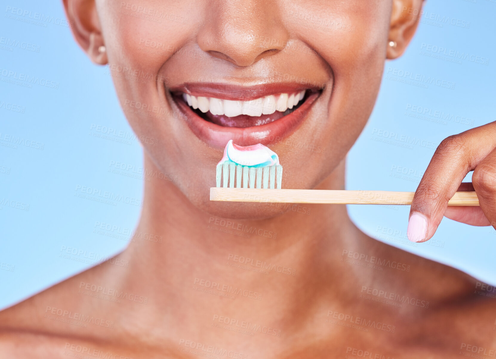 Buy stock photo Closeup, mouth or woman brushing teeth in studio for dental care, fresh breath or healthy smile on blue background. Face of happy model, eco friendly bamboo toothbrush and toothpaste of oral cleaning