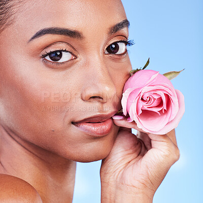 Buy stock photo Rose, face portrait and skincare of woman in studio for eco cosmetics, natural wellness or blue background. Indian model, flowers or shine of vegan beauty, sustainable dermatology or floral aesthetic