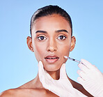 Surprise, woman face and plastic surgery, beauty and injection in portrait, doctor hands on blue background. Cosmetic treatment, wow and liquid collagen in needle syringe with skincare in a studio