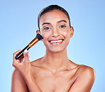 Happy woman, portrait and brush in beauty, makeup or cosmetics against a blue studio background. Female person or model smile applying skincare product in happiness for foundation or facial treatment