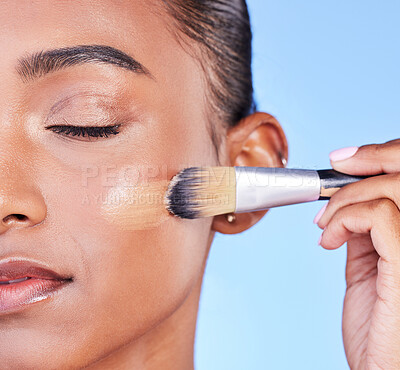 Buy stock photo Face, brush and foundation, woman and makeup with beauty closeup isolated on blue background. Cosmetic product, application and cosmetology, skin glow and wellness, powder and self care in studio