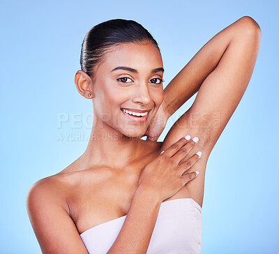 Buy stock photo Woman touching armpit in portrait, hair removal and beauty, grooming and smile isolated on blue background. Hygiene, cleaning body and epilation with skincare, cosmetics and dermatology in a studio