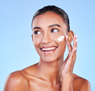 Buy stock photo Skincare, smile and product with woman and cream in studio for beauty, facial or moisturizer. Spa treatment, lotion and collagen with face of person on blue background for cosmetic, glow or sunscreen