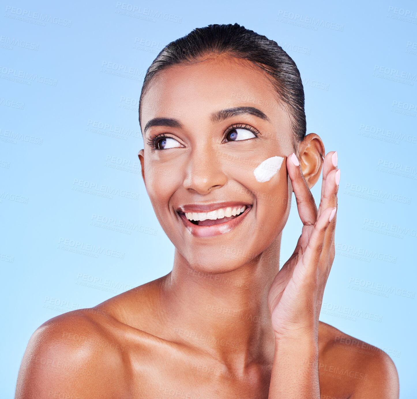 Buy stock photo Skincare, smile and product with woman and cream in studio for beauty, facial or moisturizer. Spa treatment, lotion and collagen with face of person on blue background for cosmetic, glow or sunscreen