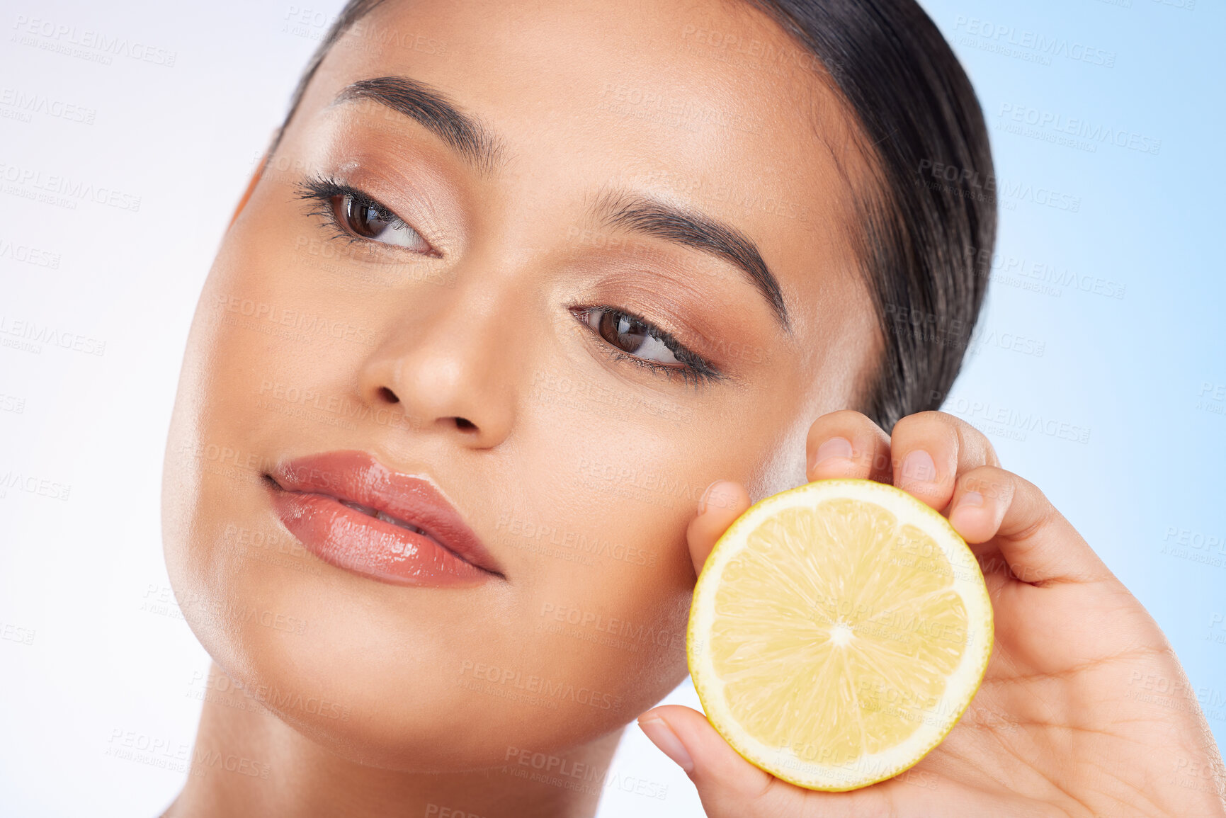 Buy stock photo Beauty, lemon and face of studio woman with citrus fruit for organic anti aging treatment, facial detox or aesthetic cosmetics. Vitamin C benefits, spa wellness and self care model on blue background