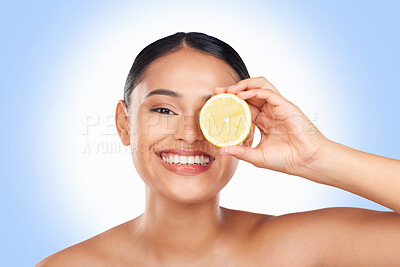 Buy stock photo Skincare, studio portrait and happy woman with lemon for organic detox treatment, natural self care routine or facial cleaning. Vitamin C benefits, fruit and face of person smile on blue background