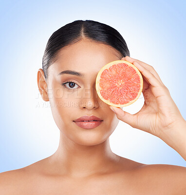 Buy stock photo Beauty skincare, portrait and woman with grapefruit for organic collagen treatment, natural self care or fruit benefits. Vitamin C, citrus product or studio face of wellness person on blue background