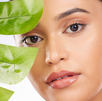 Buy stock photo Woman, portrait and plants for natural skincare, cosmetics and facial beauty on a white background. Person with green leaf for eco friendly and vegan dermatology, makeup and face skin care in studio