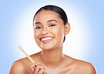 Portrait, woman and brushing teeth in studio for dental care, beauty or healthy smile on blue background. Happy model, bamboo toothbrush and cleaning mouth for oral hygiene, mint breath or gingivitis