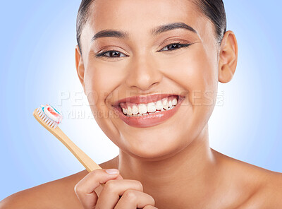 Buy stock photo Happy portrait, woman and toothbrush on blue background for dental cleaning, gingivitis and beauty in studio. Model, toothpaste and brushing teeth with bamboo for oral hygiene, healthy smile and care