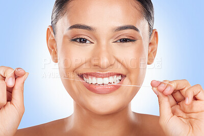 Buy stock photo Woman, portrait and floss teeth in studio for healthy dental care, gingivitis and plaque on blue background. Face, happy model and oral thread for cleaning mouth, tooth or fresh breath of gum hygiene