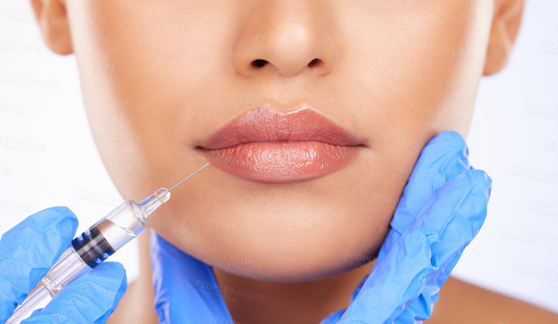 Buy stock photo Injection, woman and lips in studio for plastic surgery, beauty process and aesthetic filler on white background. Closeup, mouth and needle from surgeon for facial change, skincare and prp cosmetics 