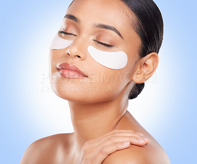 Buy stock photo Skincare, beauty and woman with eye pads for anti aging or skin glow on blue background. Cosmetics, facial detox and face of model with luxury mask or collagen product for dermatology pads in studio.