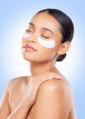 Buy stock photo Skincare, beauty and woman with collagen pads for anti aging or skin glow on blue background. Cosmetics, facial detox and face of model with luxury mask or eye product for dermatology pads in studio.