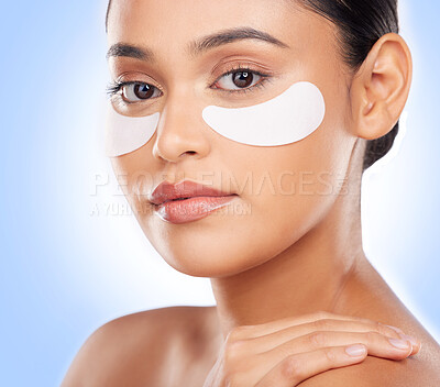 Buy stock photo Skincare, portrait and woman with eye patch for anti aging luxury skin glow on blue background. Cosmetics, facial detox and face of model with solution or collagen product for dermatology in studio.