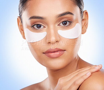 Buy stock photo Skincare, portrait and woman with collagen patch for anti aging luxury skin glow on blue background. Cosmetics, facial detox and face of model with solution or eye product for dermatology in studio.