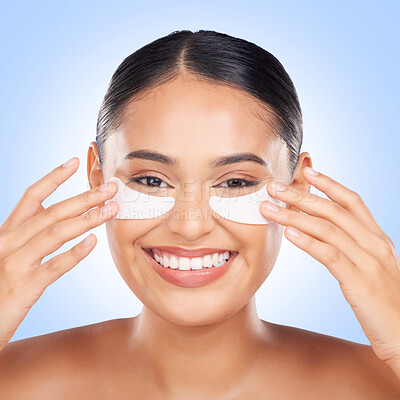 Buy stock photo Skincare, eye mask and portrait of happy woman with collagen pad for anti aging skin glow on blue background. Cosmetics, facial beauty and face of model with patches or mask for dermatology in studio