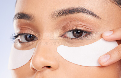 Buy stock photo Skincare, pads and eyes, portrait of woman with product on face for anti aging or skin glow on studio background. Cosmetics, facial detox and model with beauty solution or collagen for dermatology.