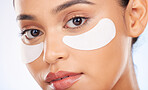 Portrait, skincare and woman with eye pads for anti aging or skin glow for beauty on studio background. Cosmetics, facial detox and face of model with patch or collagen mask for dermatology product.