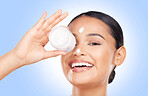 Portrait, woman and cream container in studio with facial product for aesthetic skincare on blue background. Happy model, face and beauty with sunscreen cosmetics, dermatology and moisturizer jar 