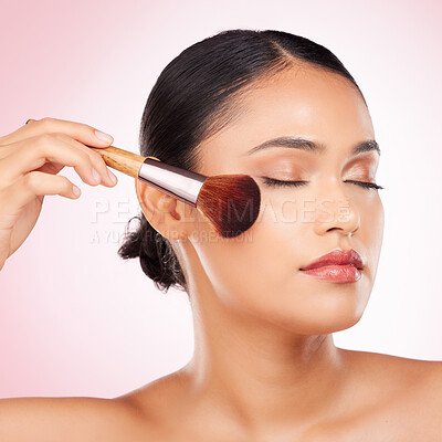 Buy stock photo Beauty, brush and young woman in studio for facial foundation, glamour and makeup treatment. Cosmetics, self care and Indian female model with cosmetology face product isolated by pink background.