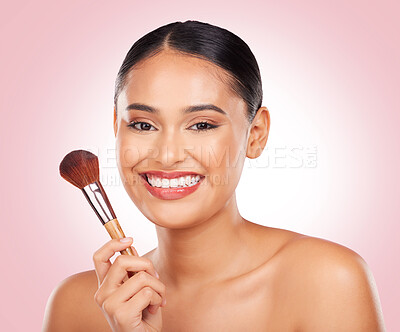 Buy stock photo Woman, makeup and portrait of brush in studio for beauty, skincare and aesthetic of face on pink background. Happy model, dermatology and cosmetics tools for foundation, facial powder and makeover 