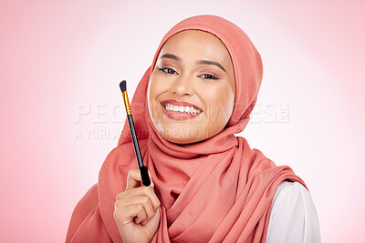 Buy stock photo Portrait, beauty and muslim woman with makeup brush in studio for wellness and cosmetics on pink background. Halal skincare, face and female with hijab for luxury, glamour or Islamic safe products