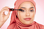 Mascara brush, portrait or Islamic woman with studio cosmetic tools, skincare or grooming facial lashes. Eyelash product application, spa salon or hijab face of Arabic Muslim model on pink background