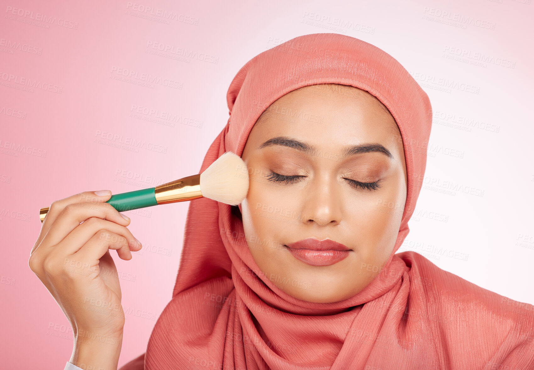 Buy stock photo Makeup, brush and muslim woman relax with from cosmetics and self care in studio. Facial, glow and wellness of female person with beauty, skincare and shine with a hijab and skin tool for face