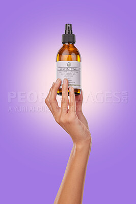 Buy stock photo Hand, oil or spray with beauty and skincare, advertising product with dermatology isolated on purple background. Wellness, cosmetics for skin toner and promotion, bottle and hyaluronic acid in studio