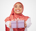 Woman, winner and gift box, offer or prize for giveaway and shopping on a white background. Muslim person in Saudi Arabia in portrait for present, ribbon package and winning or competition in studio