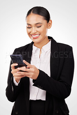 Buy stock photo Phone, communication and smile with a business woman typing a text message in studio on a white background. Mobile, networking and a happy young corporate employee reading information online