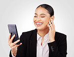 Smile, phone and earphones with a business woman in studio on a white background for communication. Smile, networking and video call with a happy young employee in a virtual meeting on her mobile