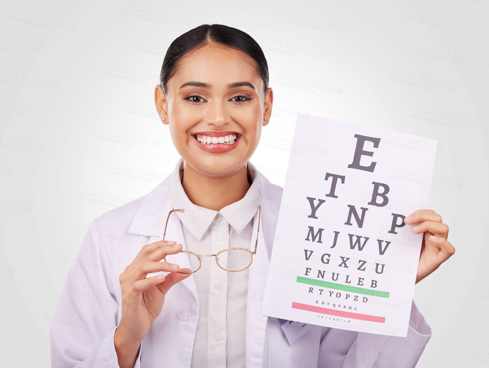 Buy stock photo Portrait, glasses and eye test with a woman optician in studio on a gray background for vision or eyesight. Face, smile and a happy young doctor in a clinic or optometry office for a medical exam