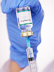 Doctor, hands and syringe with monkeypox vaccine for cure, flu shot or vaccination at hospital. Closeup of medical person or healthcare worker extracting vial or antibiotic with needle for injection