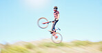 Blur, air and cyclist cycling in nature training for a competition on trail or path in forest or woods. Freedom, wheelie stunt or athlete riding bicycle to jump in cardio exercise, fitness or workout